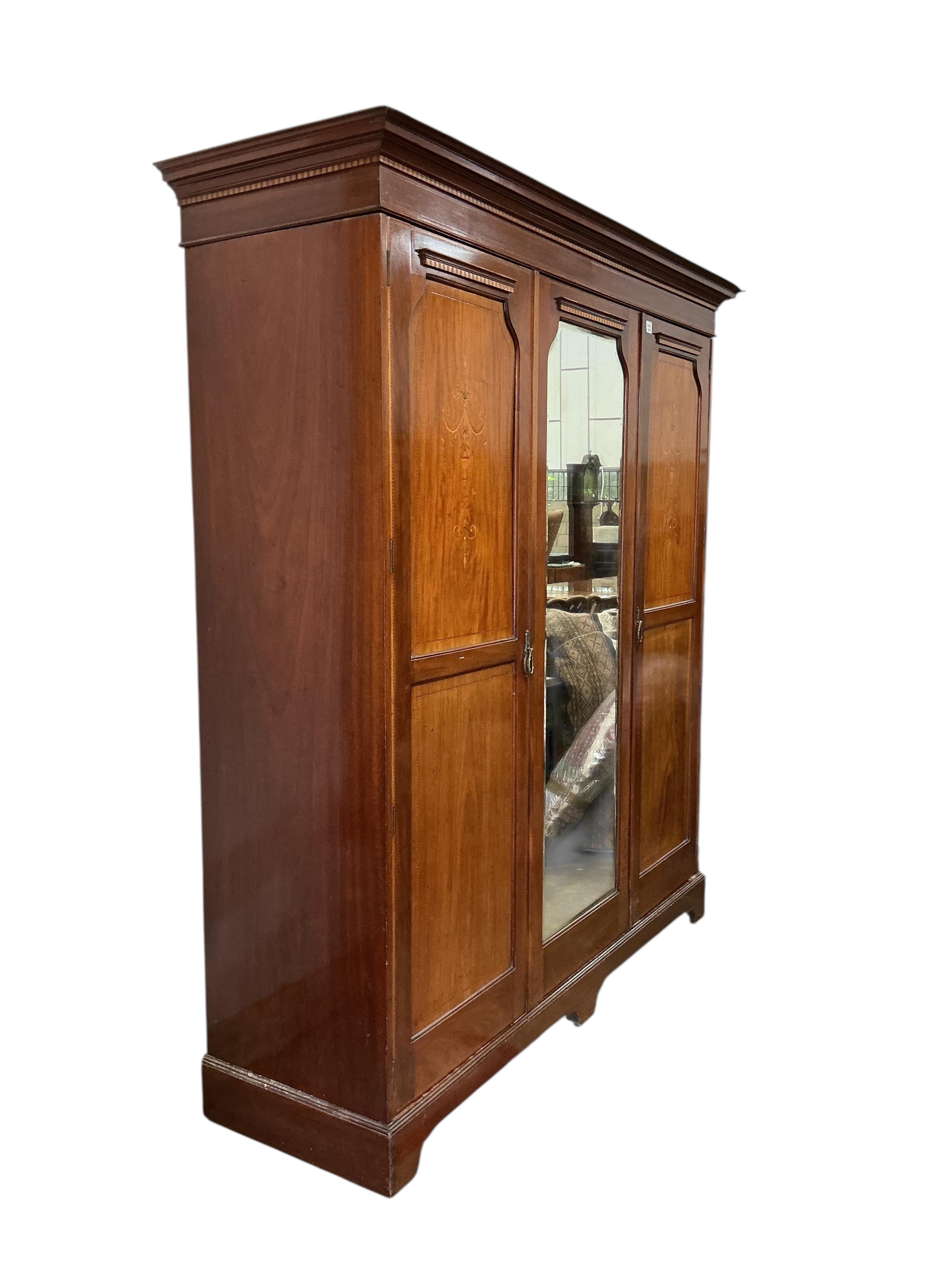 An Edwardian inlaid mahogany mirrored wardrobe, width 194cm, depth 61cm, height 214cm